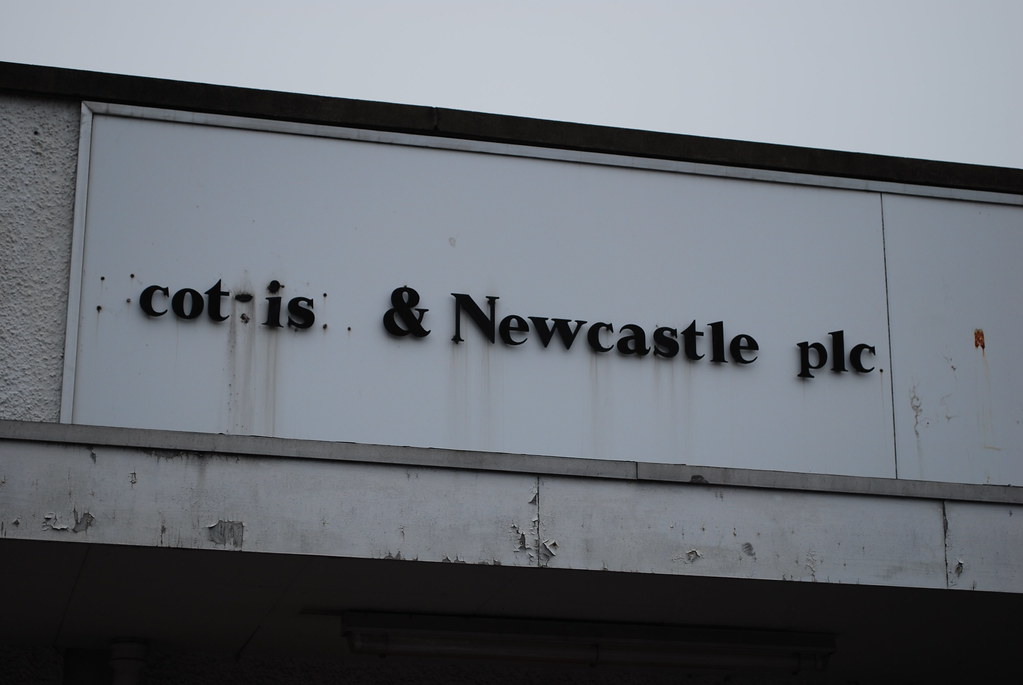 Crumbling sign on the old Scottish & Newcastle plc building