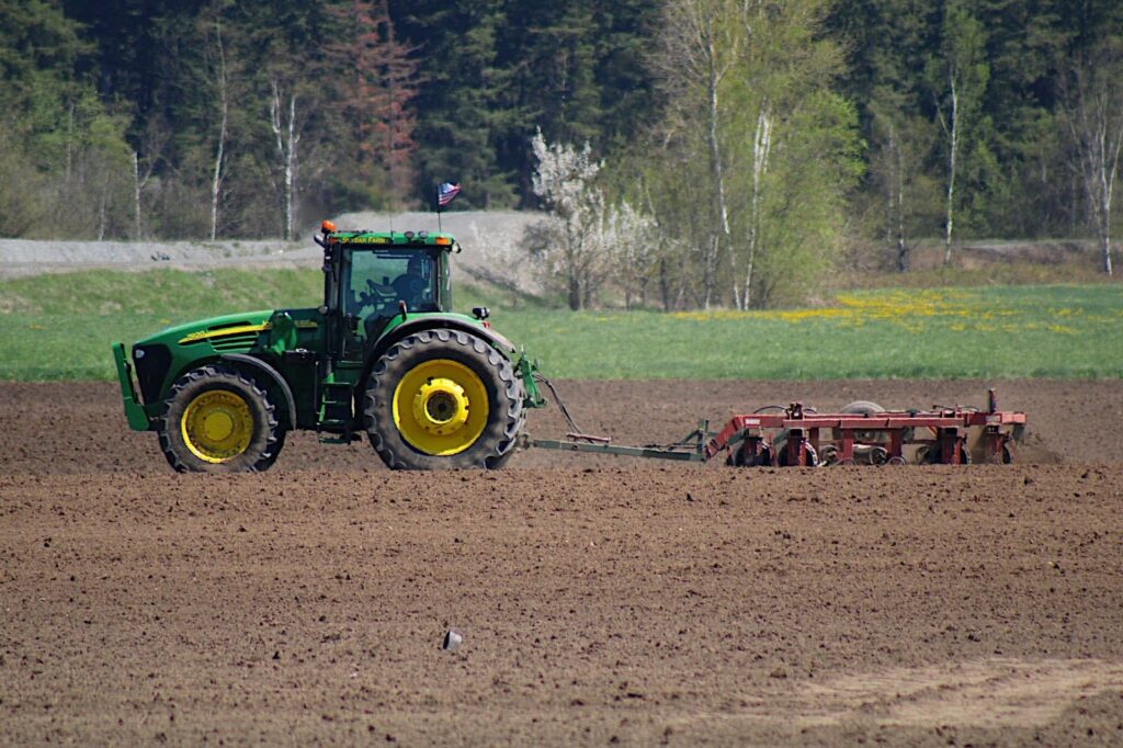 Tractor dragging plow in field